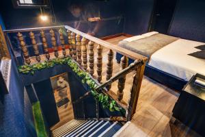 a staircase leading up to a room with two beds at The Clock Hostel & Suites in Cartagena de Indias