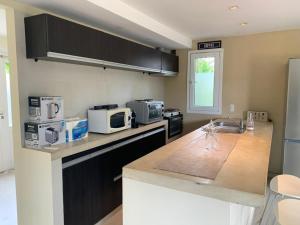 a kitchen with a counter top with a microwave at Silenios in Pinamar