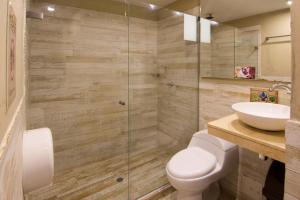 a bathroom with a toilet and a sink at The Clock Hostel & Suites in Cartagena de Indias