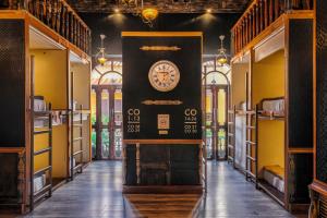 a hallway with a clock on a wall in a building at The Clock Hostel & Suites in Cartagena de Indias