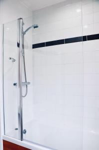 a shower with a glass door in a bathroom at The Liverpool Pod Travel Hostel in Liverpool