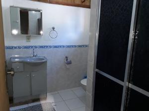 a small bathroom with a sink and a toilet at Pousada Bom Bocado in São Pedro da Serra