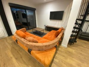 a large couch sitting in a living room at La Sècherie de Waldam pour 4 personnes in Oye-Plage