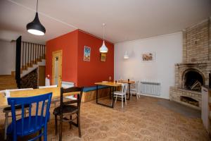 a dining room with a table and a fireplace at Vardeni Guesthouse in Hrazdan
