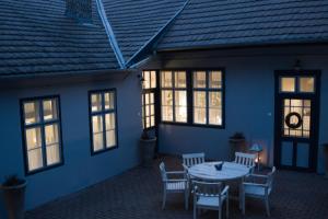 a patio with a table and chairs in a house at Ister Guesthouse in Esztergom
