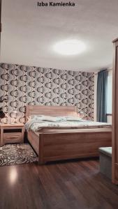 Un dormitorio con una cama grande y una pared en Villa Korálka en Liptovský Trnovec