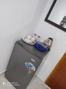 a small refrigerator with a plate on top of it at Kings House in San Andrés