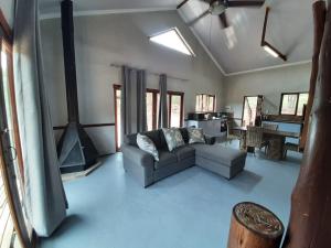 a living room with a couch and a fireplace at Rock Cottage, Bela-Bela in Bela-Bela