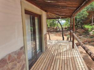 a porch of a house with a glass door at Rock Cottage, Bela-Bela in Bela-Bela +24 photos