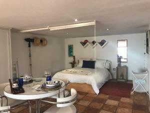 a bedroom with a bed and a table and a table and a bed at Loft La petite in Guatiza