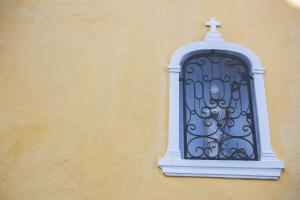 a blue window with a cross on the side of a building at Sintra1012 Boutique Guesthouse in Sintra