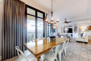a dining room and living room with a table and chairs at Phoenix West in Orange Beach