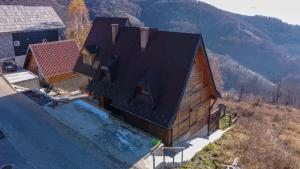an overhead view of a house with a swimming pool at HostGost Mountain Houses - Vila Zarić in Kopaonik +25 photos