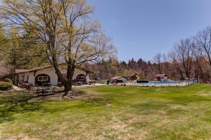 a large yard with a house and a swimming pool at N10 Sandtrap Loop in Bartlett