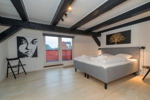 a bedroom with a bed and a chair in it at Modern Luxury Penthouse in Sønderborg