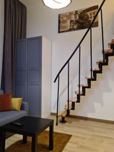a living room with a couch and stairs at Amber Hostel in Krakow