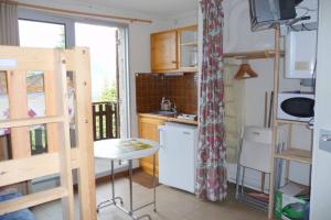 a small kitchen with a small table in a room at Studio dans station de ski aux pieds des pistes in Selonnet +24 photos