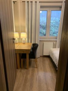 a room with a desk and a bed and a window at Kurort Kozubnik Apartament 12 in Porąbka