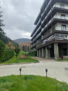 a large building with a bench in front of it at Kurort Kozubnik Apartament 12 in Porąbka