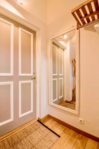 a room with a door and a mirror at Lossi 32 Apartment in Tartu