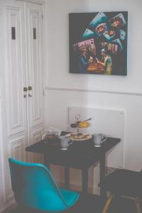 a dining room with a table and a blue chair at Sintra1012 Boutique Guesthouse in Sintra
