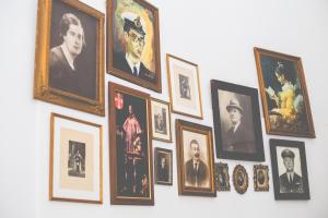 a bunch of framed pictures hanging on a wall at Sintra1012 Boutique Guesthouse in Sintra