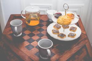 a table with a plate of food and a drink at Sintra1012 Boutique Guesthouse in Sintra