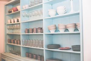 a shelf filled with dishes and bowls and plates at Sintra1012 Boutique Guesthouse in Sintra