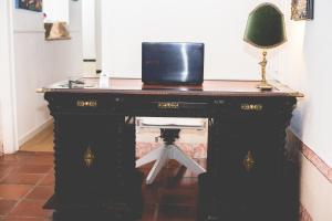 a black desk with a lamp on top of it at Sintra1012 Boutique Guesthouse in Sintra