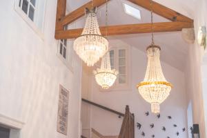 three chandeliers hanging from the ceiling in a hallway at Sintra1012 Boutique Guesthouse in Sintra
