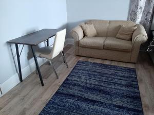 a living room with a couch and a table at Close to center in Winnipeg