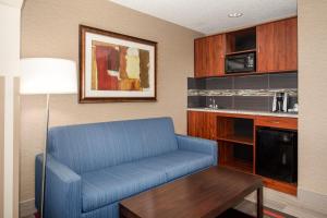 a living room with a blue couch and a table at Holiday Inn Express Hotel & Suites Littleton, an IHG Hotel in Littleton