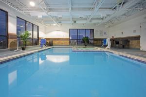 a large swimming pool with blue water in a building at Holiday Inn Express Hotel & Suites Littleton, an IHG Hotel in Littleton