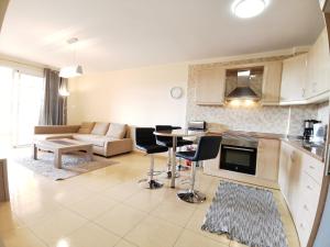 a kitchen and living room with a table and chairs at Well refined apartment - stunning pool in Palm-Mar