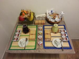 a table with food and fruits on top of it at Appartamento B&B Suite Stefanelli in Taranto