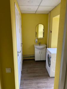 a bathroom with a sink and a washing machine at Хостел Мажор in Kharkiv