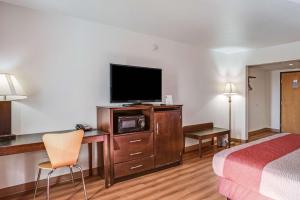 a hotel room with a bed and a flat screen tv at Motel 6-Levittown, PA - Bensalem in Levittown