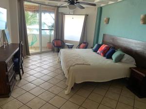 a bedroom with a bed and a table and chairs at El Encanto Casa Boutique in Manzanillo