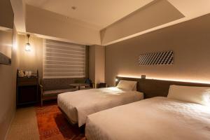 Säng eller sängar i ett rum på Royal Park Hotel Kurashiki