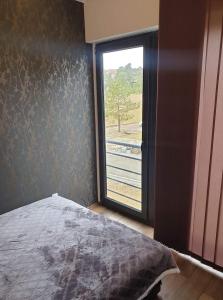 Łóżko lub łóżka w pokoju w obiekcie Apartman Ruzmići Divčibare