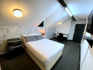 a bedroom with a large white bed and a desk at Townhouse 105 in Huddersfield