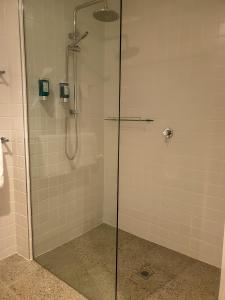 a shower with a glass door in a bathroom at Nagambie Waterfront Motel in Nagambie