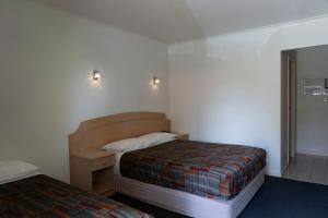 Postel nebo postele na pokoji v ubytování Nunawading Motor Inn