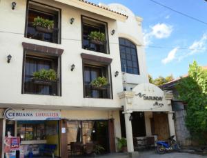 a building with potted plants in the windows at Darunday Manor in Tagbilaran City