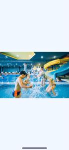 a group of people in the water at a water park at TeonaLux Kraljevi Cardaci 5a/22 in Kopaonik