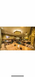 a large room with tables and chairs and a television at TeonaLux Kraljevi Cardaci 5a/22 in Kopaonik