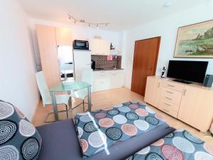 a living room with a bed and a table at BodenSEE Apartment Kressbronn Fischerdorf SEE 1 in Kressbronn am Bodensee