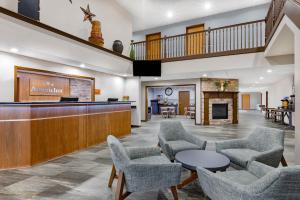 a lobby of a hospital with chairs and a bar at AmericInn by Wyndham Pella in Pella