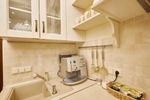 a kitchen with a sink and a microwave at Petrani Central in Kyiv