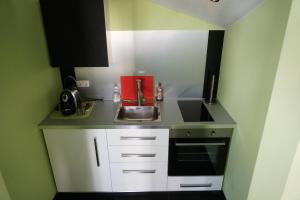 Kuchyň nebo kuchyňský kout v ubytování Hotel Come In